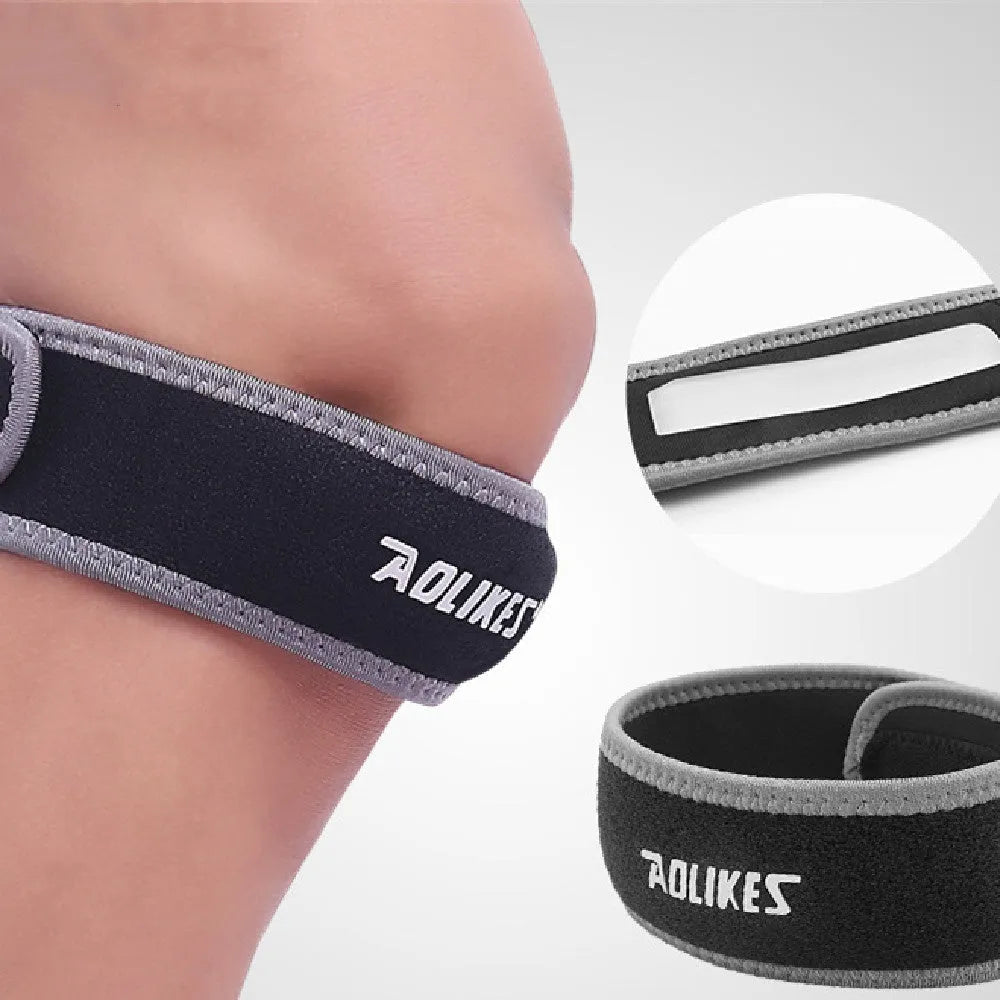 Black and grey patella retinaculum knee brace for sports protection.