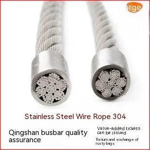 Close-up of a multi-strand 304 stainless steel anti-theft security cable coiled on a dark surface.