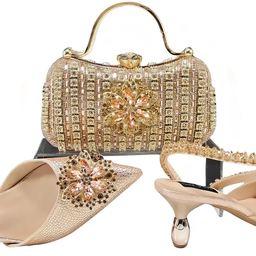 Black high heel ankle strap shoes with floral buckle and matching rhinestone clutch bag.