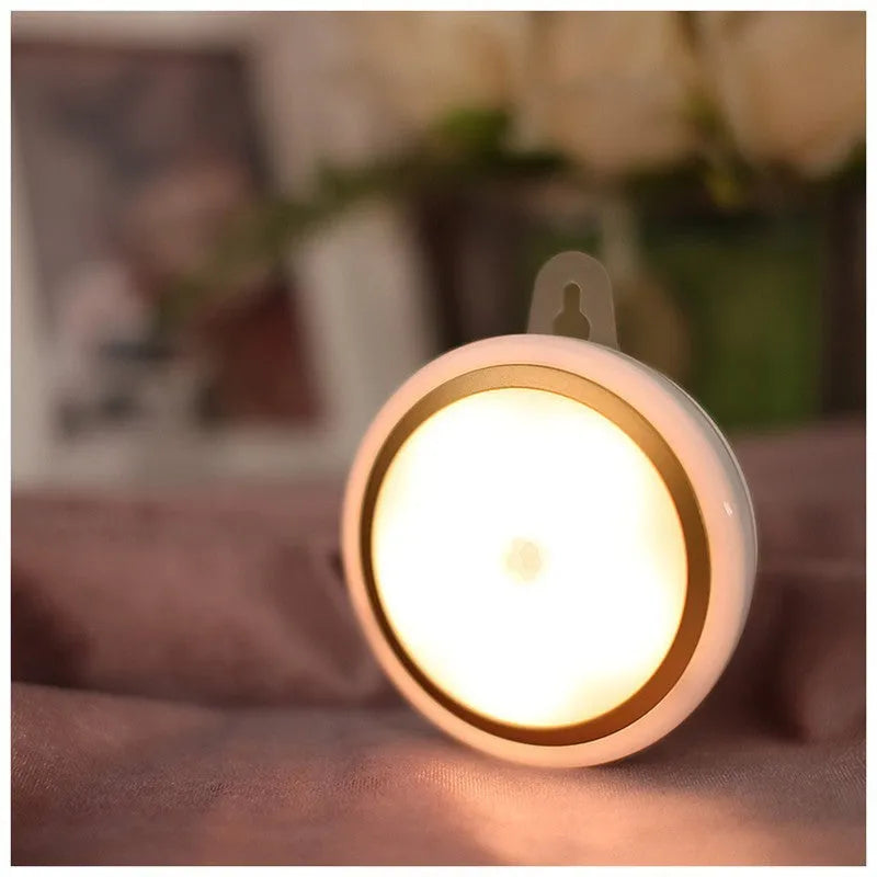 Compact circular white motion sensor LED light with 80mm diameter for automatic wardrobe or corridor lighting.