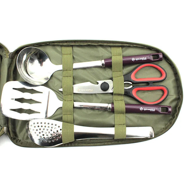 8-piece stainless steel camp kitchen utensil set in black storage bag on outdoor table