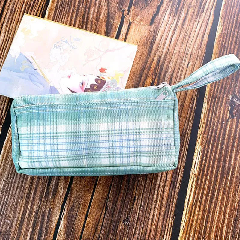 Square double-layer canvas stationery bag in a red stripe grid pattern.