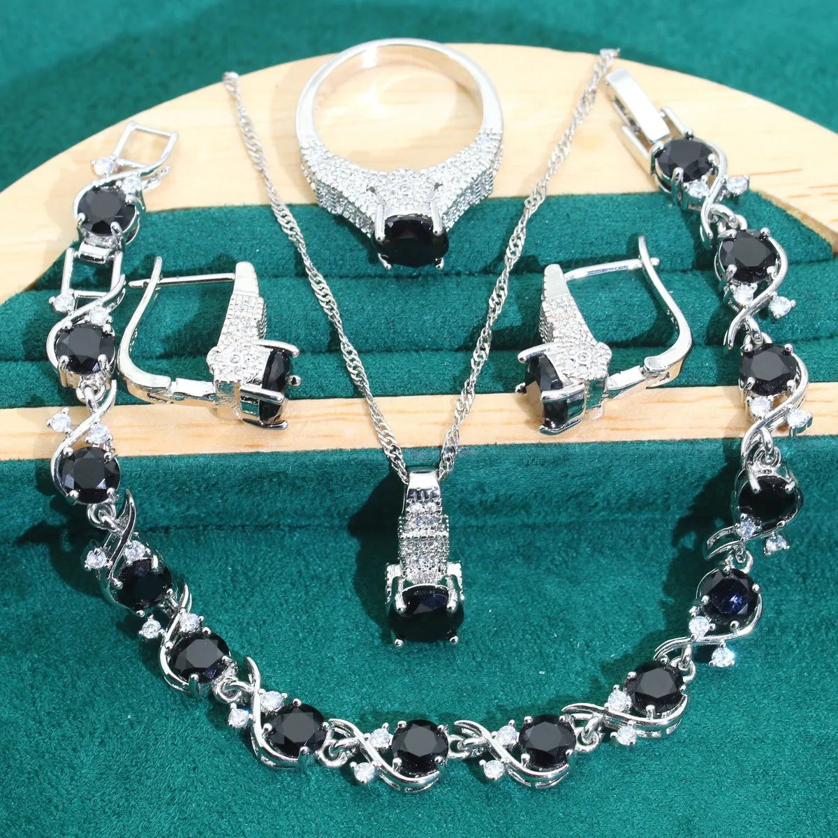 Bridal zircon and alloy four-piece jewellery set showing necklace, earrings, bracelet, and ring in white colour