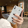 Clear glitter TPU back cover case for iPhone on a table, showing purple colour option.