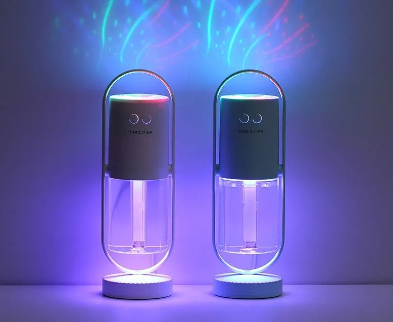 Pink Magic Shadow USB air humidifier with projection night lights on a wooden table.