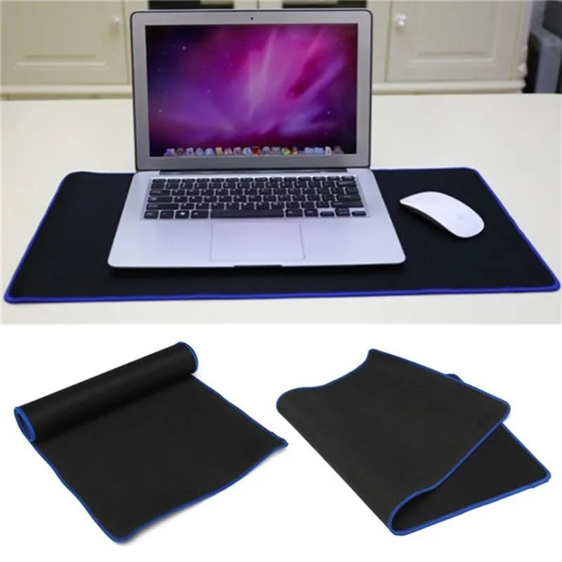 Oversized rubber mouse pad 30x60cm with stitched edge in black on a desk