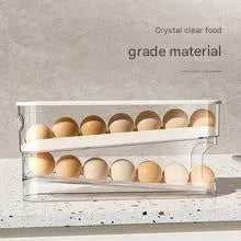 White plastic slide-out egg tray for refrigerator door with automatic dispenser and clear view window.