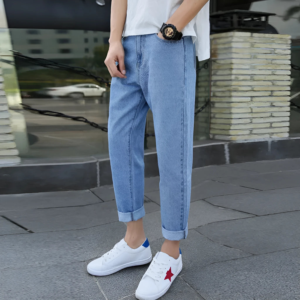 Men's loose fit straight leg jeans in black and blue colours showing harem style.