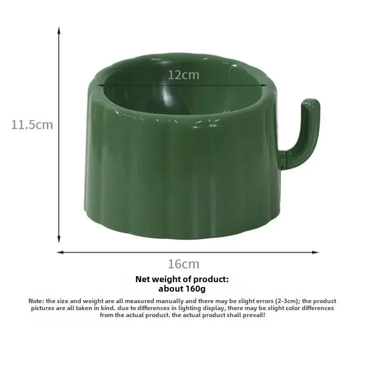 Solid green cat bowl with cactus pattern and anti-slip base on a kitchen floor.