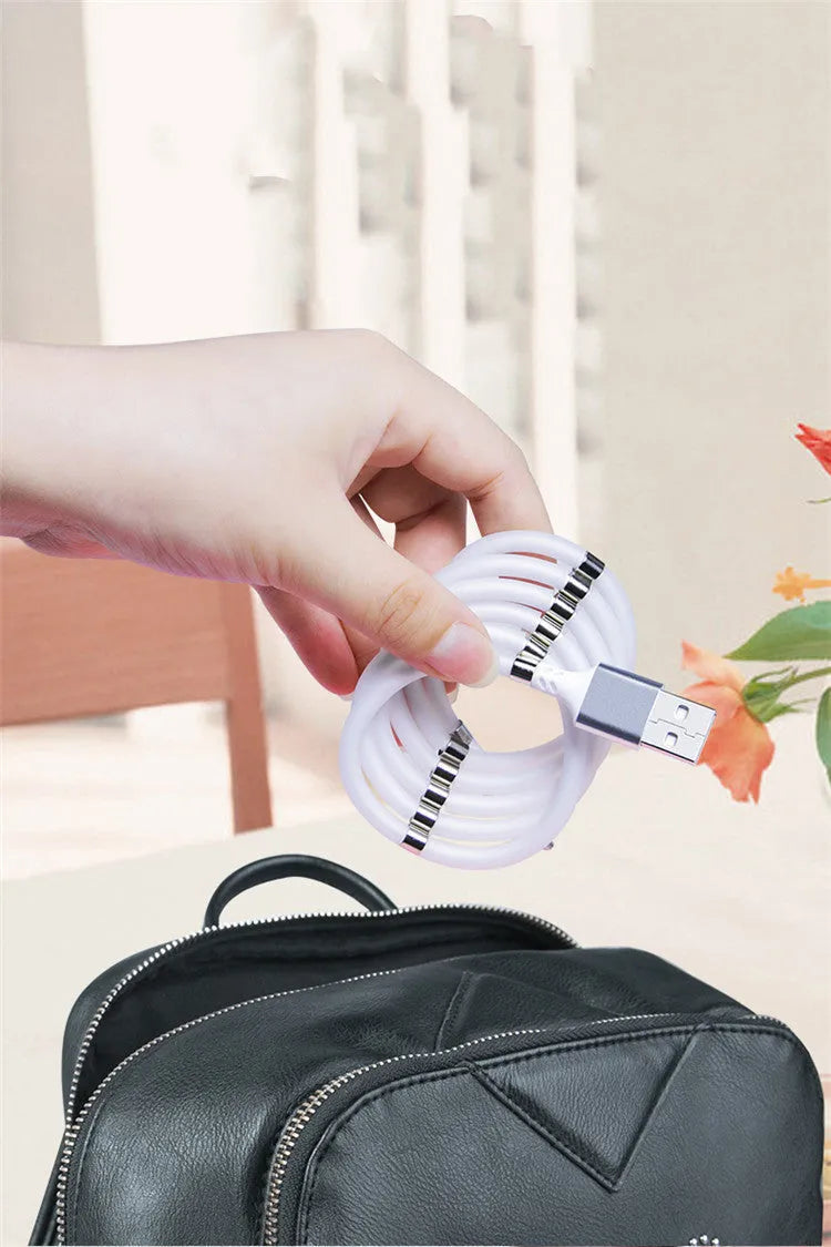Black magnetic charging cable with multiple connector heads including USB-C, Micro USB and Apple-compatible 3.5mm
