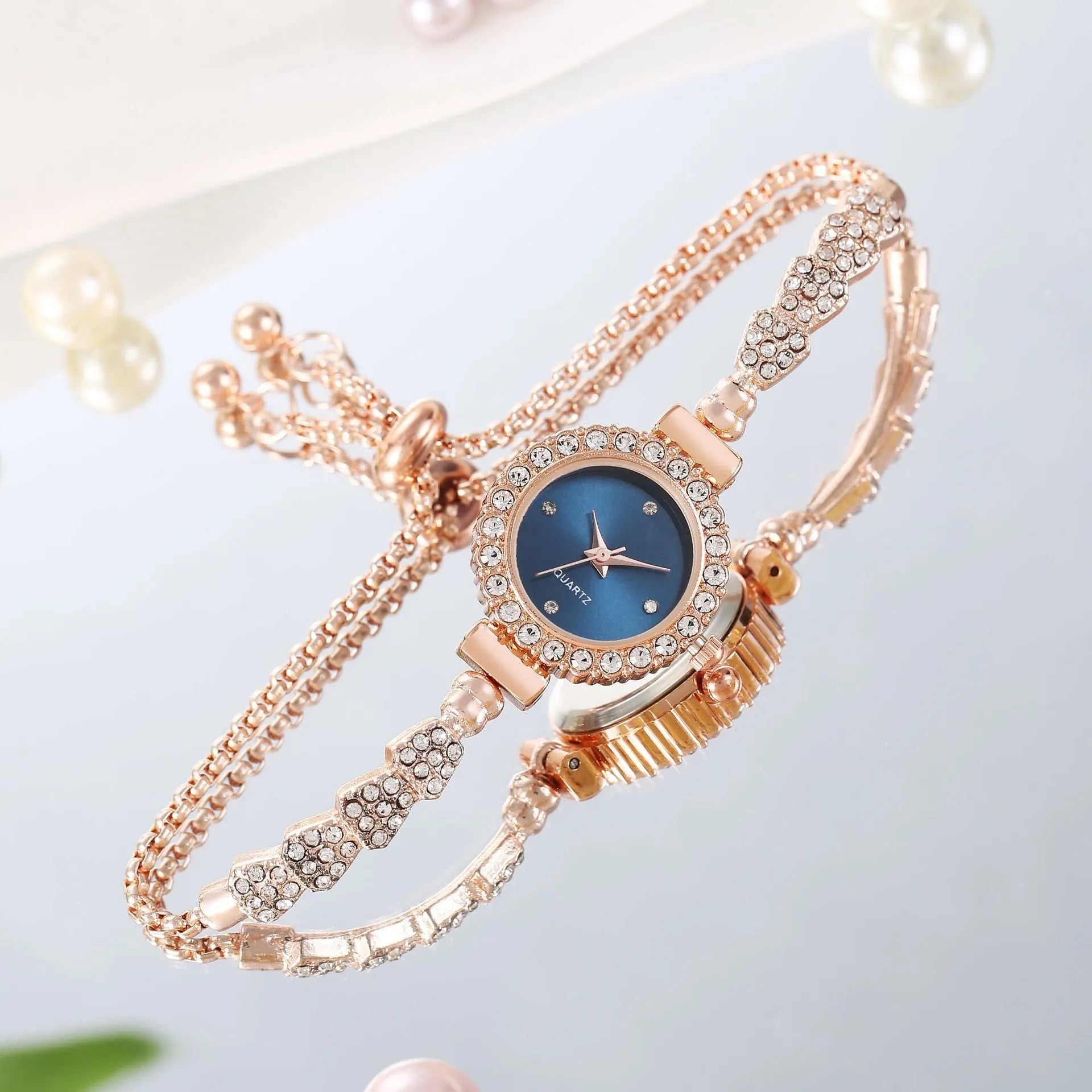 Gold fine strap women's watch with round dial and stainless steel jewellery buckle