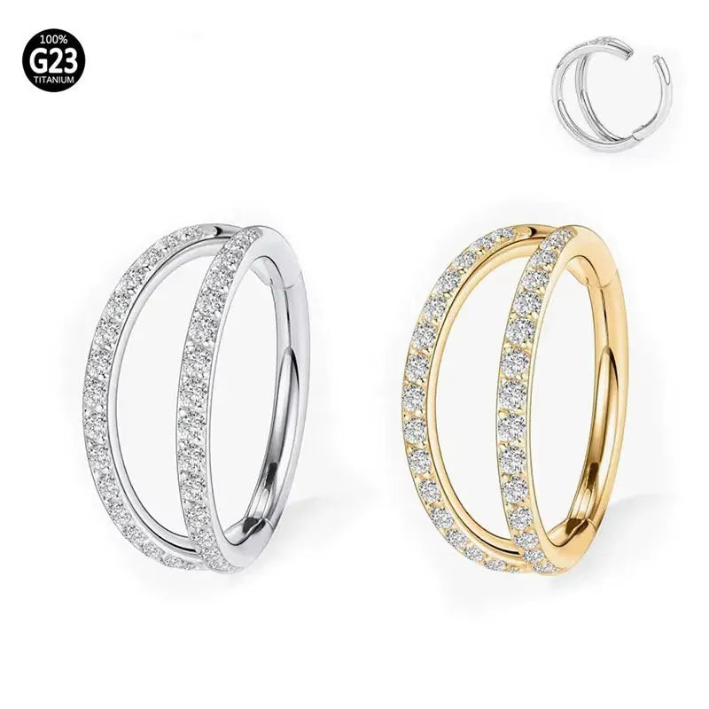 G23 titanium alloy nose ring with monoclinic diamond treatment in gold and steel colour on a grey background.