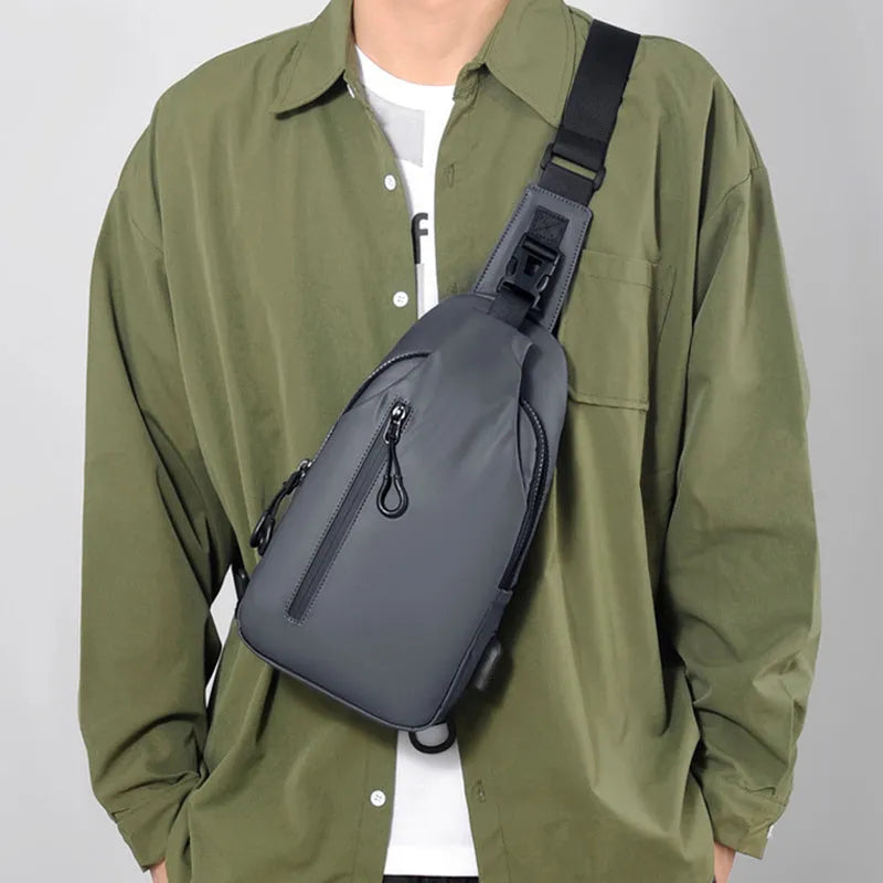 Black sling crossbody backpack for men with zip closure and soft handle, solid colour