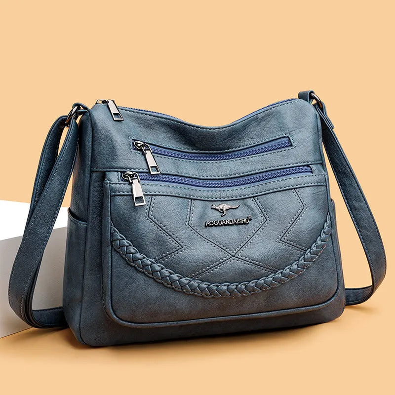 Soft leather crossbody shoulder bag in horizontal square design with zippered internal pocket