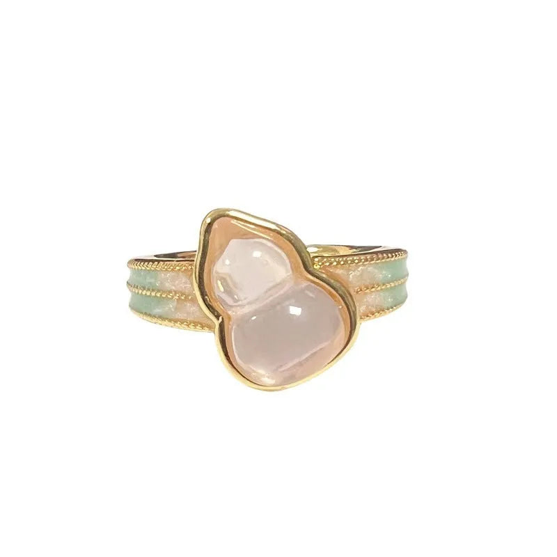 Close-up of an adjustable copper ring with a vintage oil-drip finish and a central gourd motif set with zircon stones.