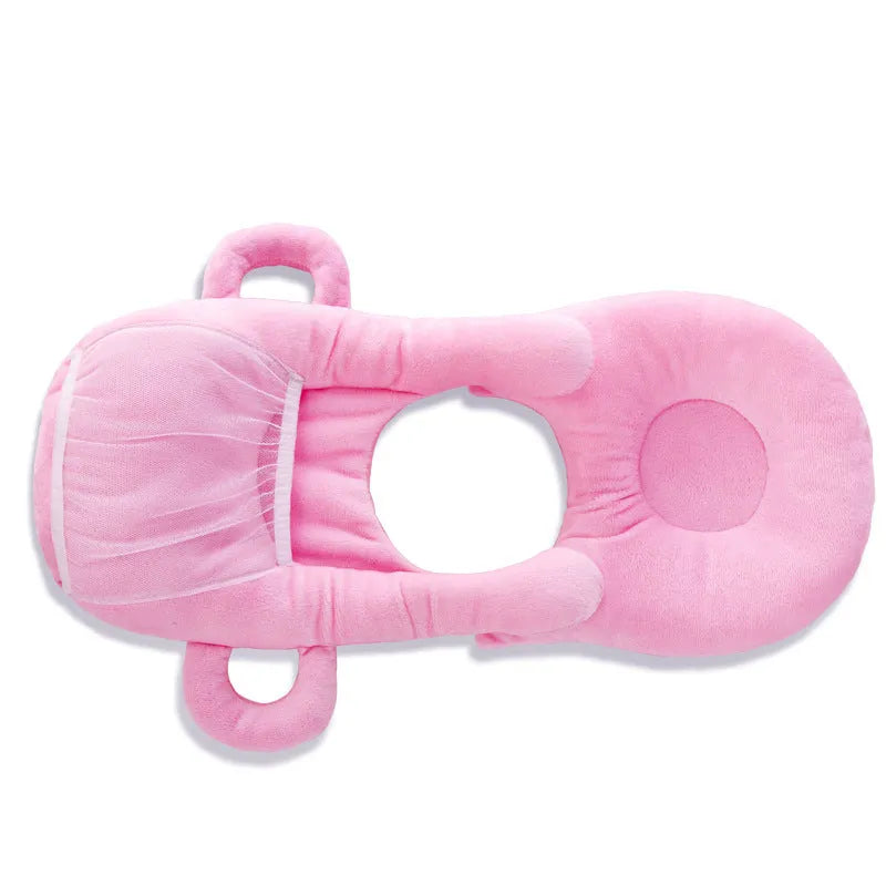 Pink plush baby feeding pillow on a carpet, showing its 30cm by 42cm size and soft texture.