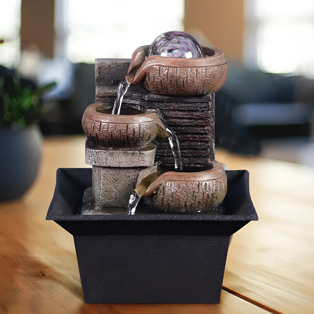 European desktop fountain with crystal ball and flowing water on a wooden desk
