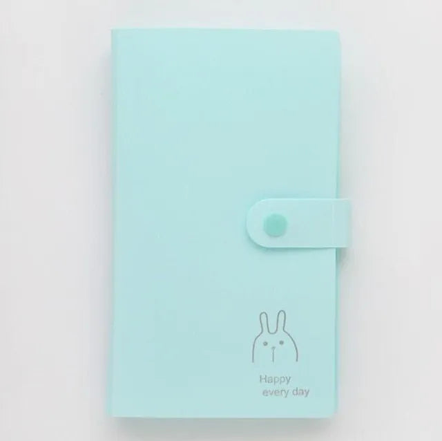 Blue PVC and PP business card holder book with protective shell, showing smile logo and insert slots.