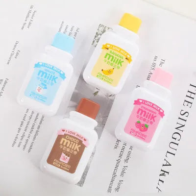 A cute, patterned bottle-shaped correction tape dispenser with a curved design, shown on a paper surface.
