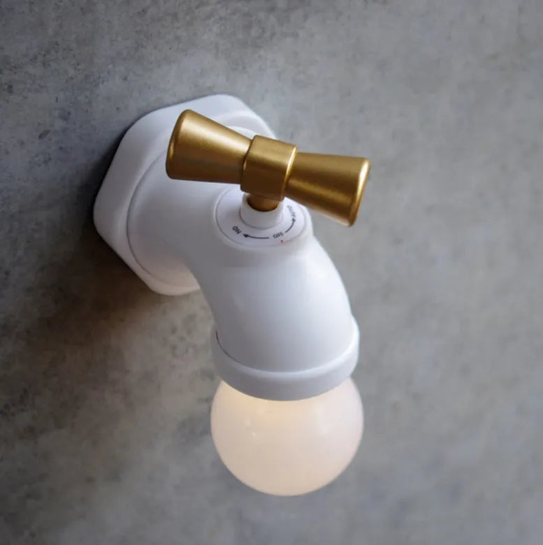 Black and white faucet-shaped USB rechargeable night lamp with sound activation feature