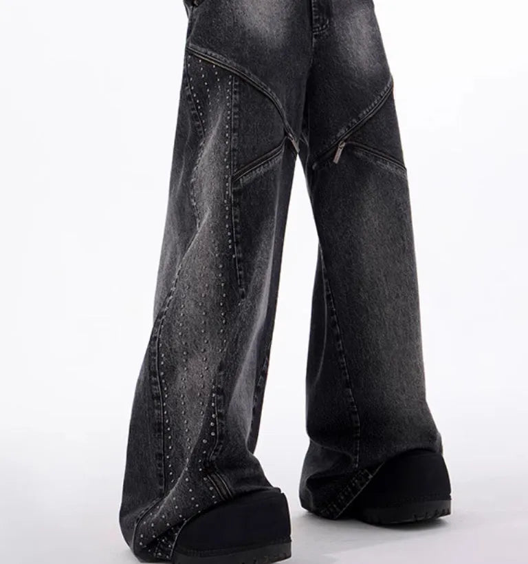 Black and grey washed wide leg cotton denim trousers and matching waistcoat set laid flat.