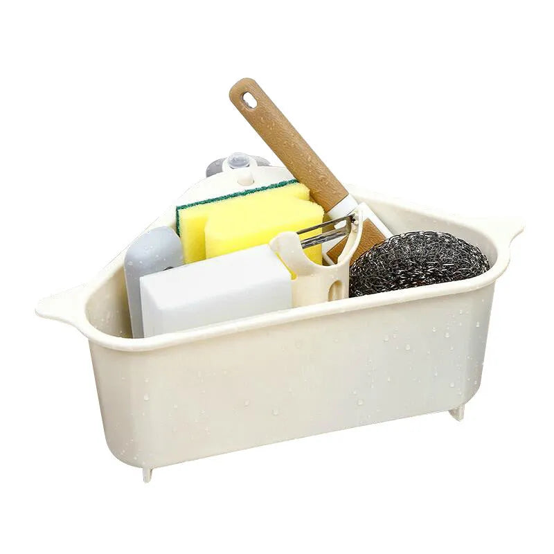 Beige plastic triangle kitchen sink rack holding a sponge and soap, hanging from a faucet.
