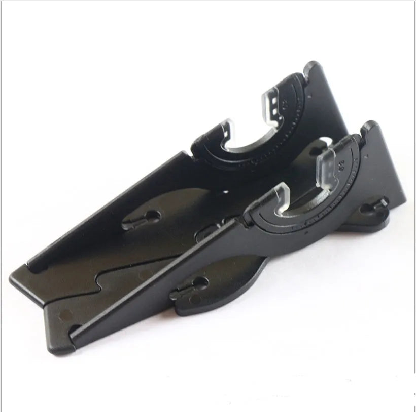 A black plastic card-type mobile phone holder on a desk, holding a smartphone.