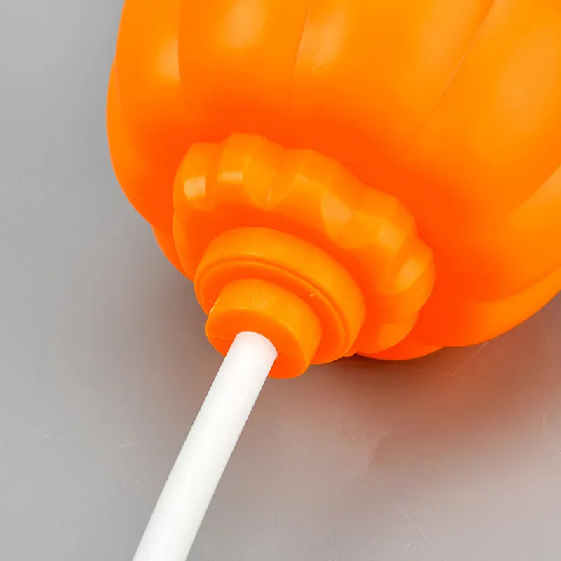 Plastic pumpkin lamp with USB charging cable showing yellow and purple light options
