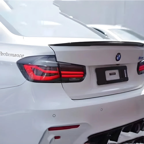 BMW 3 Series modified LED tail light assembly in red or black smoke finish, showing streamer running light design.