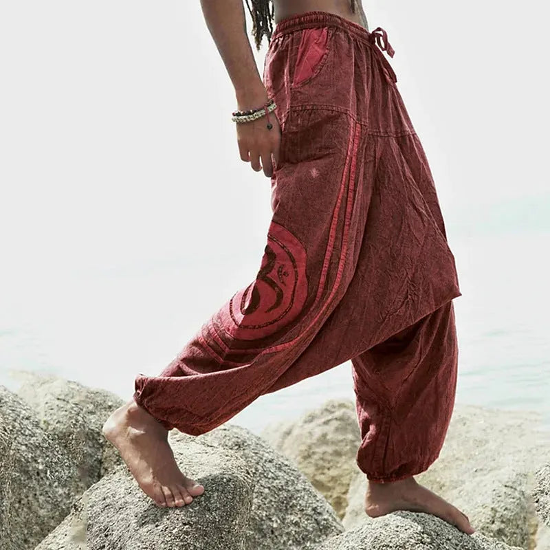 Dark green men's trousers with ethnic pattern design showing ankle-tied detail and mid-waist fit