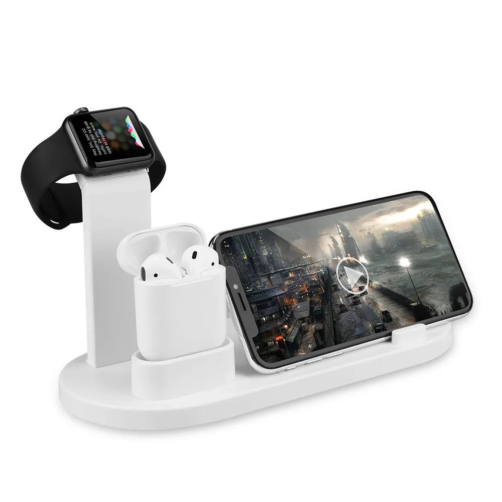 White aluminium wireless charging stand holding phone, headphones and smartwatch