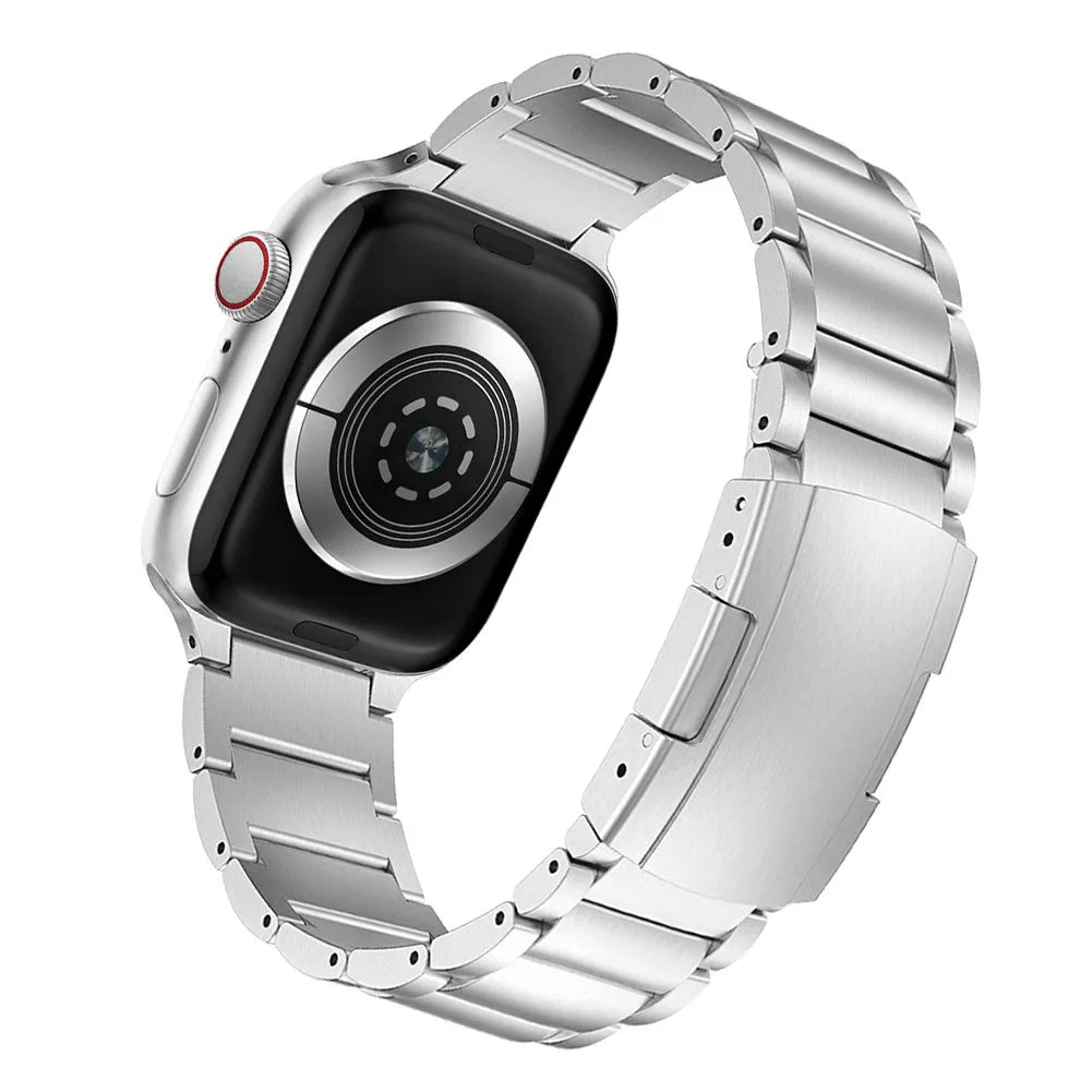 Black titanium metal band with folding buckle for Apple Watch on a grey background