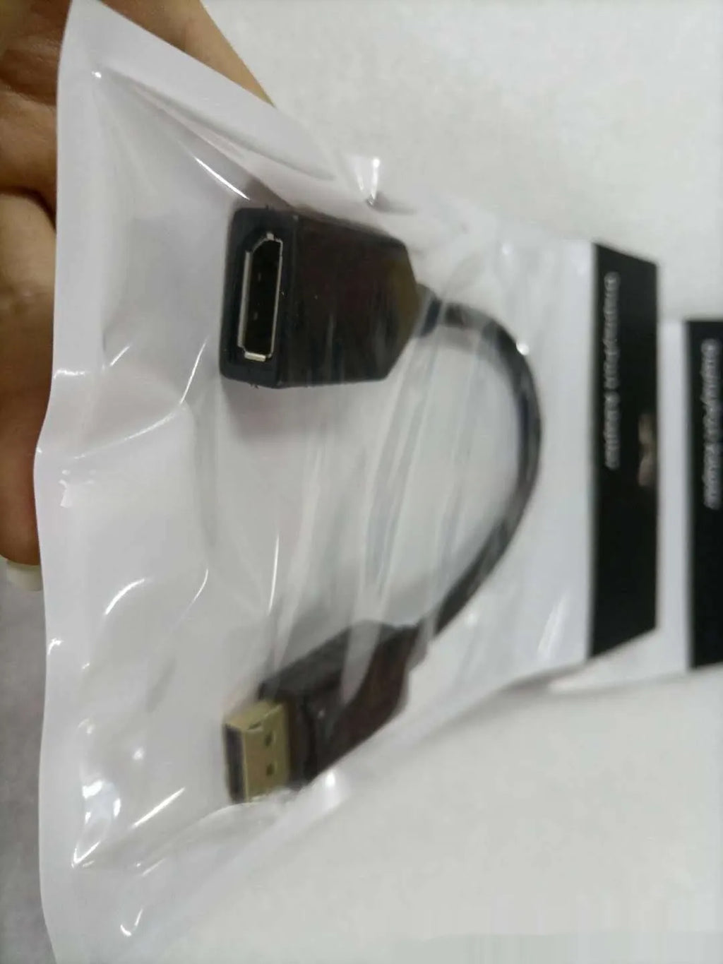 Black DisplayPort male to female extension cable approximately 10cm long with rotating connector