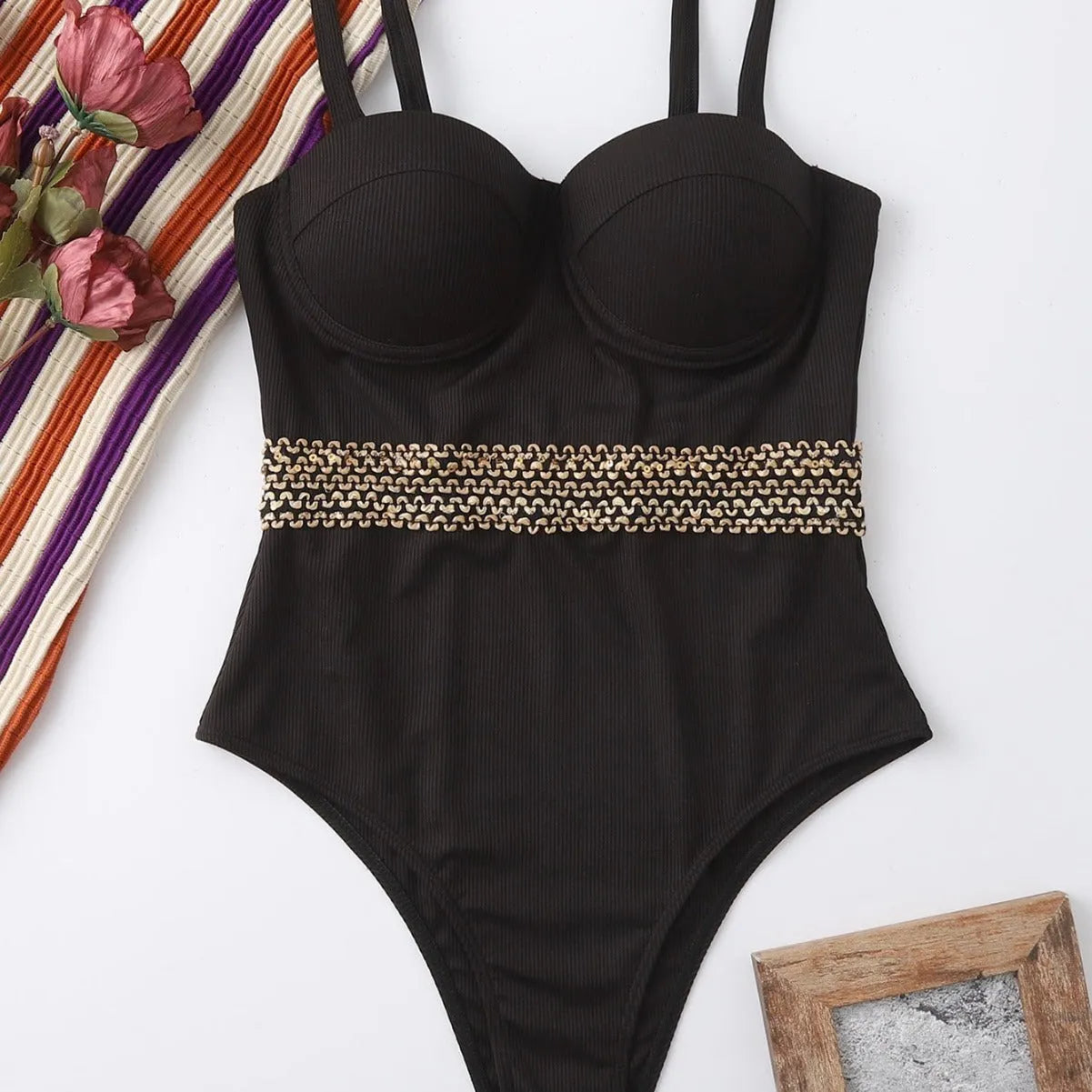 Black one-piece swimsuit with adjustable shoulder strap on a mannequin