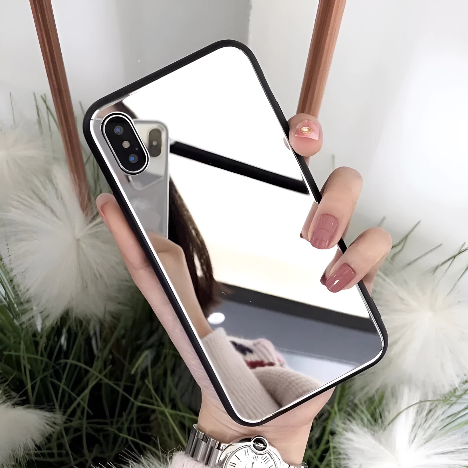 Black mirror phone case for Apple iPhone models X, 7 Plus, and 8 Plus on a table.
