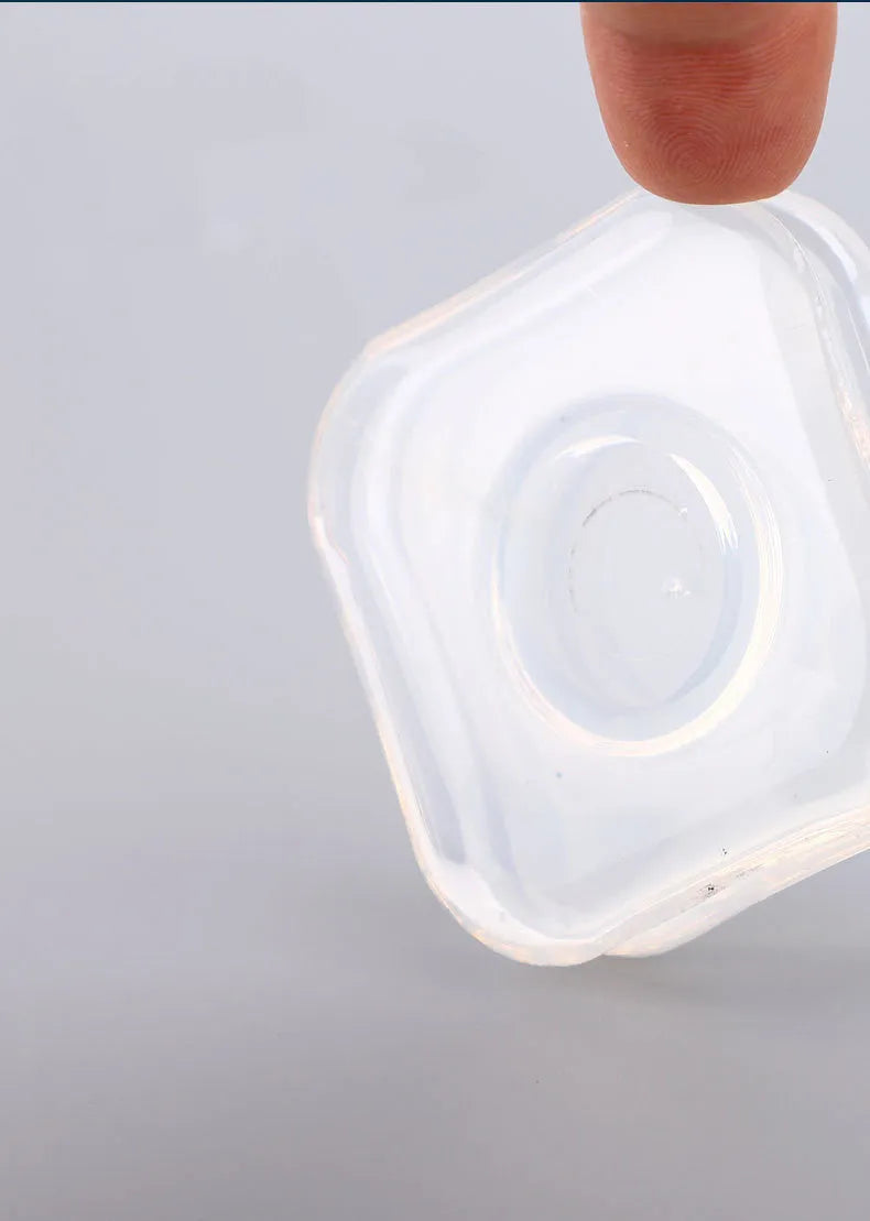 Transparent circular and square silicone nano gel adhesive pads on a car dashboard holding a mobile phone.
