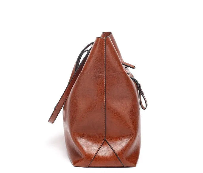 Brown waxed cowhide crossbody handbag showing two main compartments and an internal phone pocket.