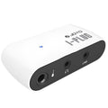 White metal portable headphone amplifier with multi-effects distortion, shown with batteries and connector.