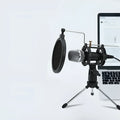 Black or silver condenser microphone on aluminium stand with 3.5mm and USB cables for mobile phone and computer broadcasting