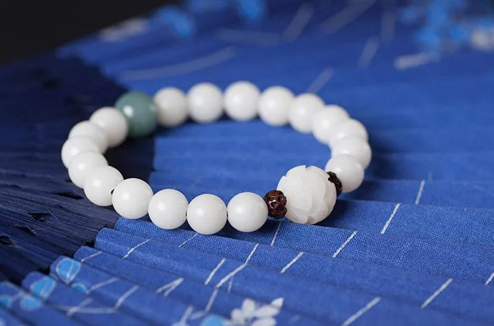 Natural white jade Bodhi bracelet with round beads and transfer bead on white background