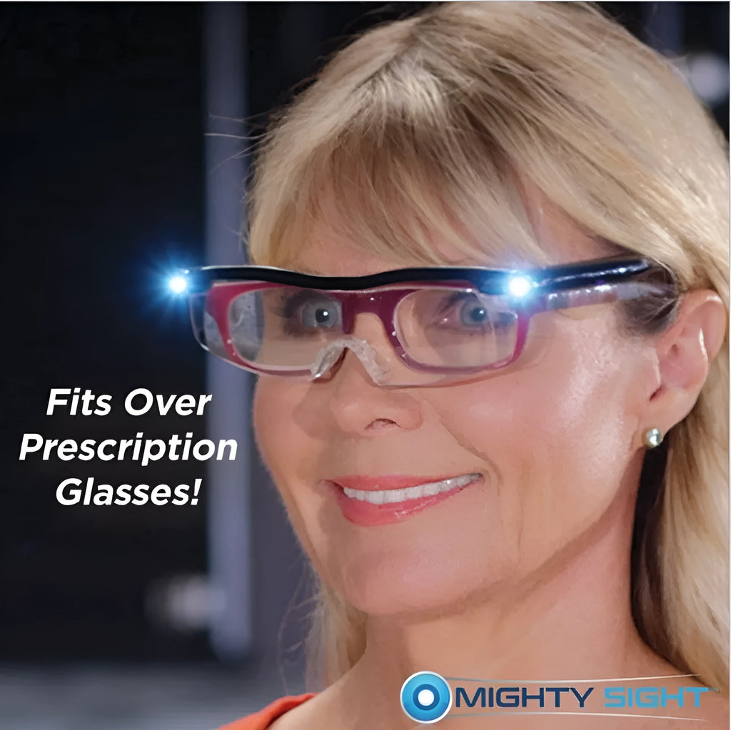 Transparent black USB rechargeable reading glasses with integrated LED light on a dark surface