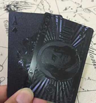 Black Diamond waterproof plastic poker cards with gold foil finish showing laser-etched diamond pattern on black background
