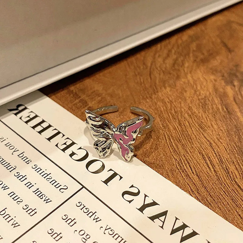 Copper butterfly women's ring with dripping oil texture and an open loop design.
