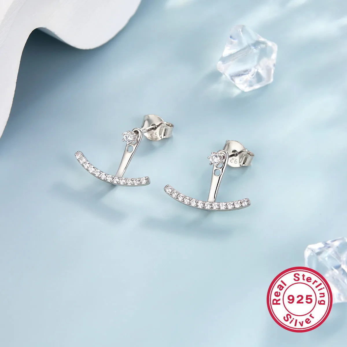 925 silver smile earrings with French diamond-embedded continuous stone setting, geometric U-shape, on a light background