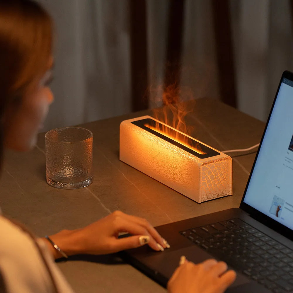 USB lava flame humidifier in black or white with colourful simulated flame and aromatherapy function on a desktop