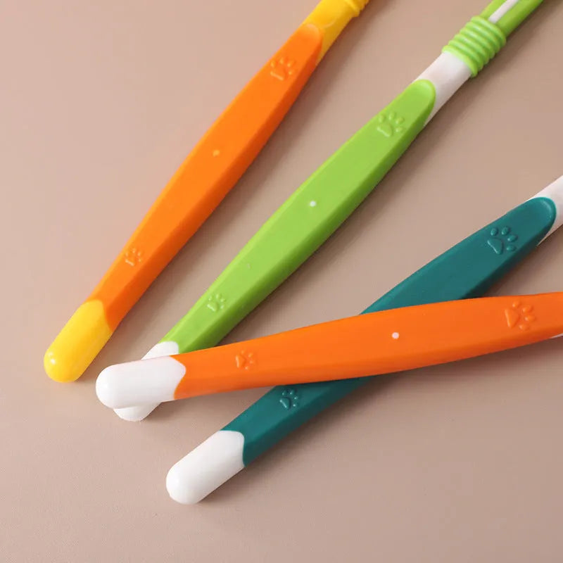 Pet toothbrush in assorted colours including orange, green, yellow, blue pink, and black and yellow.