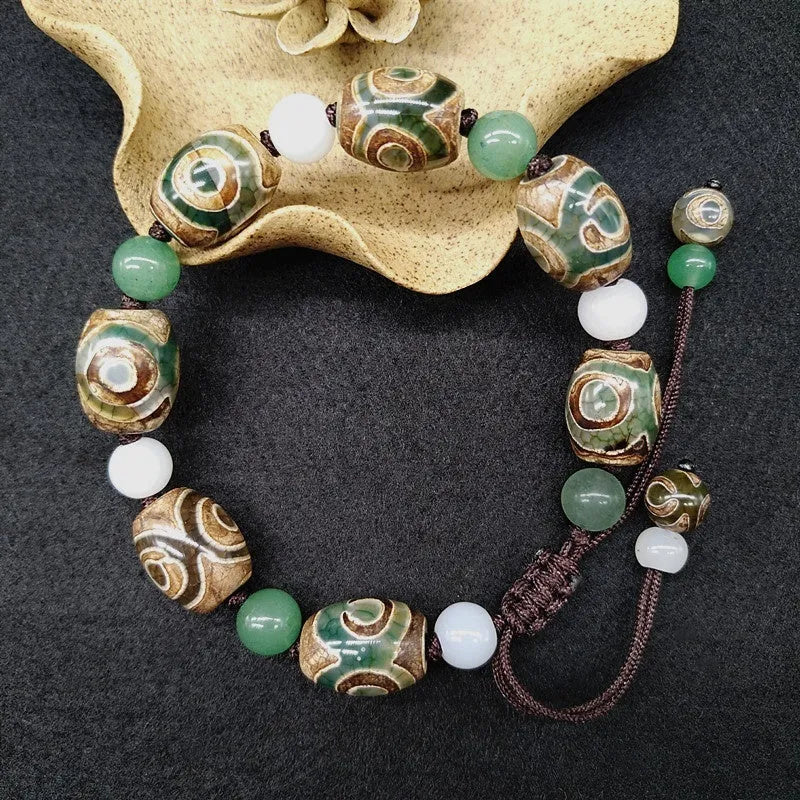 Green agate ethnic bracelet with three eye Tibet beads in hand-woven geometric pattern