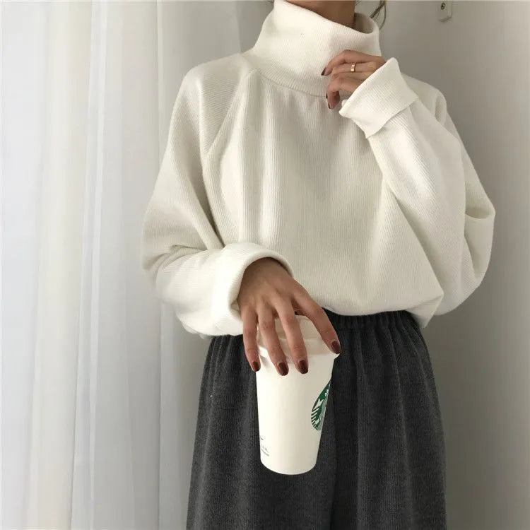 Women's solid colour loose-fit top with a half-high collar and long sleeves in apricot.
