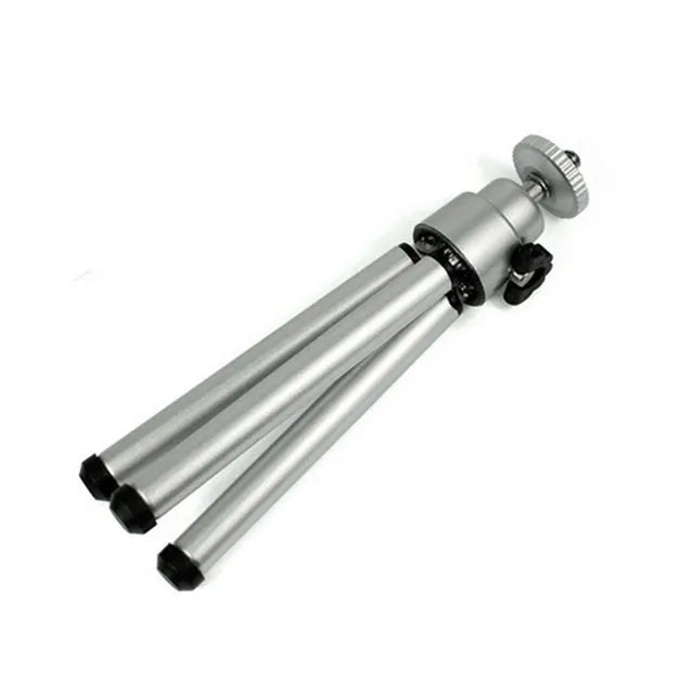 Mini aluminium tripod with extended legs and a black U-shaped phone clip attached