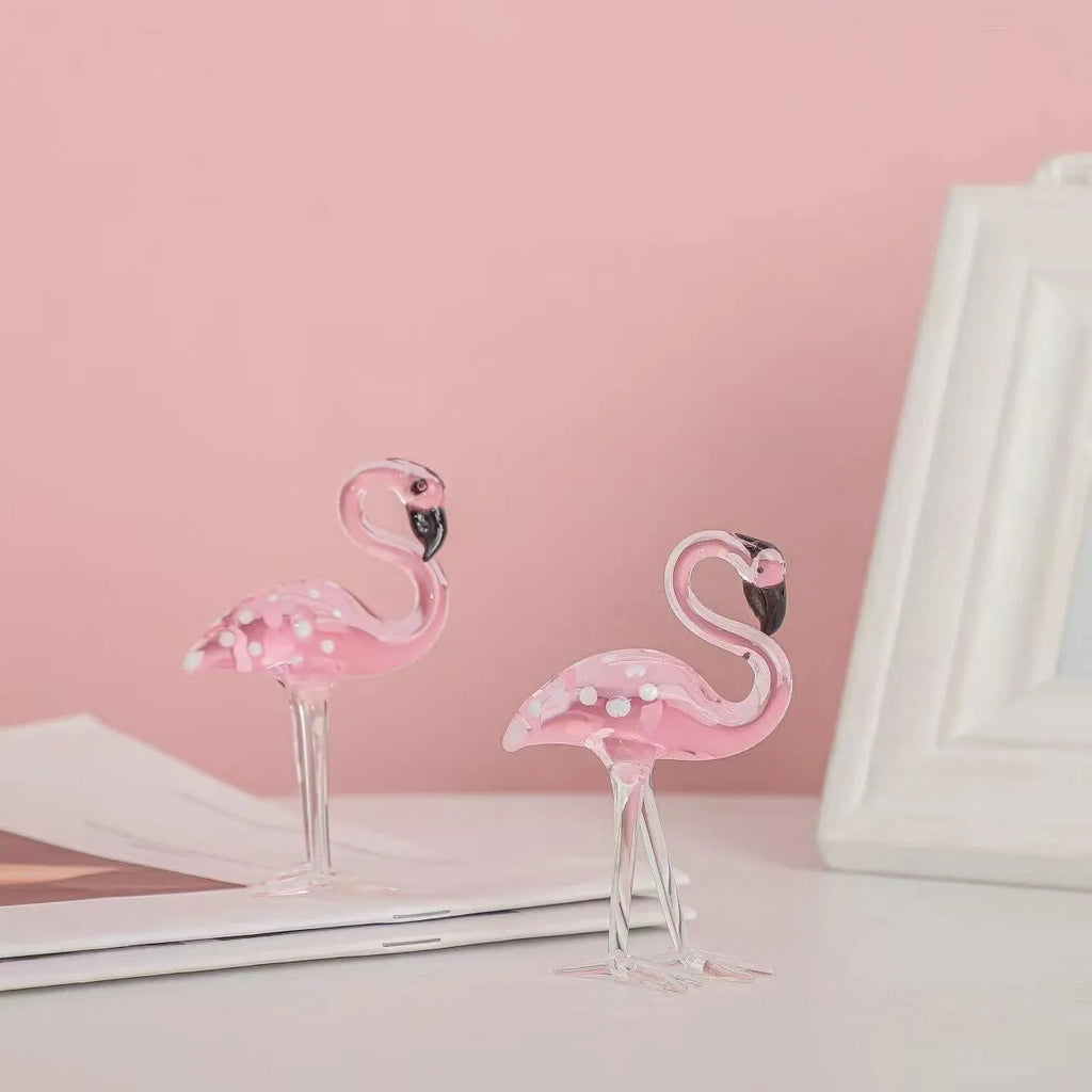 Pink crystal flamingo decorative figure on a table in modern style.